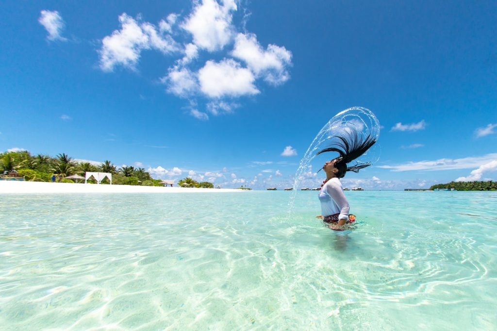 photo of woman half body submerged on body of water